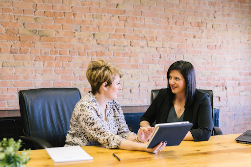 Two women in an office talking